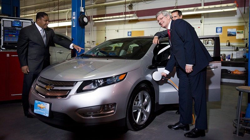 Prime Minister Stephen Harper plugs in a GM Volt electric car