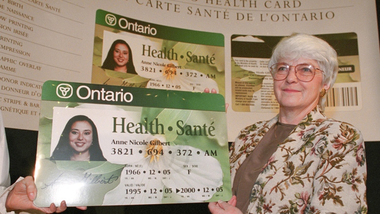 Then-Ontario Health Minister Ruth Grier holds up an enlarged version of Ontario's new health card in Toronto on Jan. 20, 1995. (Phill Snel / THE CANADIAN PRESS)