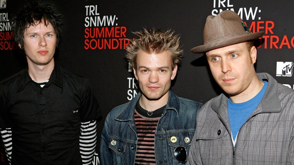 Members of the Ontario, Canada-based band Sum 41 Cone McCaslin, left, Deryck Whibley, center, and Steve Jocz, right, pose backstage during MTV's "Total Request Live" at the MTV Times Square Studios Thursday, May 31, 2007 in New York. (AP / Jason DeCrow)