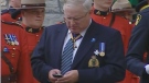 RCMP Commissioner William Elliott uses his BlackBerry at the funeral of Const. Michael Potvin, Aug. 4, 2010.