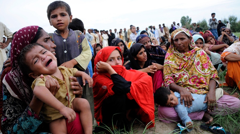 People rescued from flooded villages wait for food relief in Muzaffargarh near Multan in central Pakistan on Friday, Aug. 6, 2010. (AP / Khalid Tanveer)