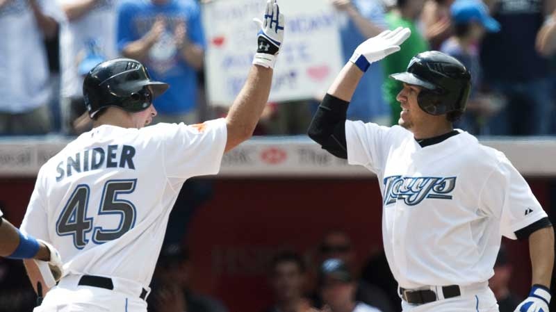 Toronto Blue Jays' J.P. Arencibia, right, is congratulated by teammateTravis Snider after hitting a two-run home run against Tampa Bay Rays during a baseball game in Toronto on Saturday, Aug. 7, 2010. (Nathan Denette / The Canadian Press)