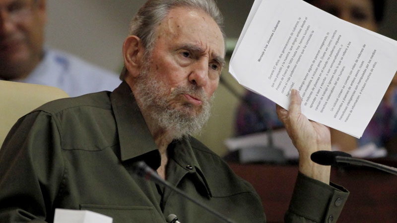 Fidel Castro holds up documents titled in Spanish "Message to young Cubans" as he speaks at a special session of parliament, his first official government appearance in front of lawmakers in four years in Havana, Cuba, Saturday Aug. 7, 2010. (AP / Javier Galeano)