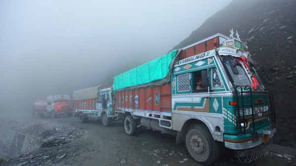 Thick clouds surround stranded trucks near the Zojila pass on the Leh-Srinagar Highway, some 120 kilometres north east of Srinagar, India, Saturday, Aug. 7, 2010. (AP / Dar Yasin)