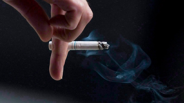 A person smokes a cigarette. (Pawel Dwulit / THE CANADIAN PRESS)