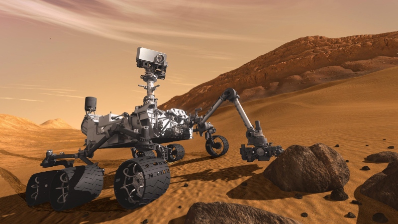 The Mars Science Laboratory Curiosity rover examines a rock on Mars in this 2011 artist's rendering. (NASA/JPL-Caltech)