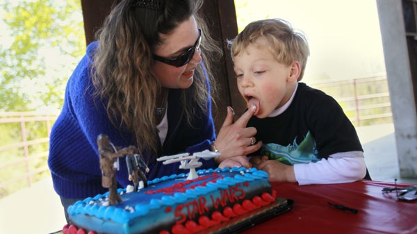 In this Saturday, April 10, 2010 picture, Sandy Wilson gives her son, Christopher, 5, a taste of his birthday cake's frosting before the party in Columbia, Md. (AP / Jacquelyn Martin)