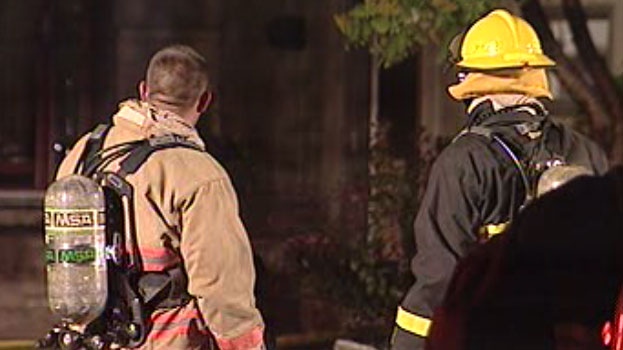 Fire crews look on after a house fire is extinguished on Cameo Crescent Wednesday night.