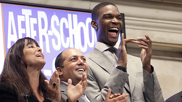 Miami Heat forward Chris Bosh, right, joins in applause during opening bell ceremonies at the New York Stock Exchange Wednesday, July 28, 2010. (AP Photo/Richard Drew)