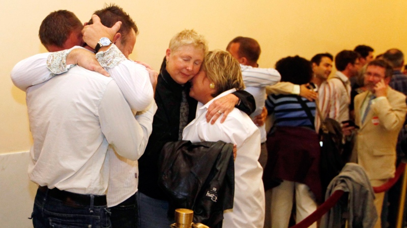 Same-sex couples waiting in line to be married from left Sarah Shuchter and April Williamson, of Pacifica, Calif., Robert Huddleston and Chris Holler of San Francisco, react to the news that they may not marry for at least another week Thursday, Aug. 12, 2010, in San Francisco. (AP / Eric Risberg)