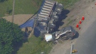 A gravel truck and an SUV sit on the side of the road following a collision near Stouffville, Ont., Friday, Aug. 3, 2012. 