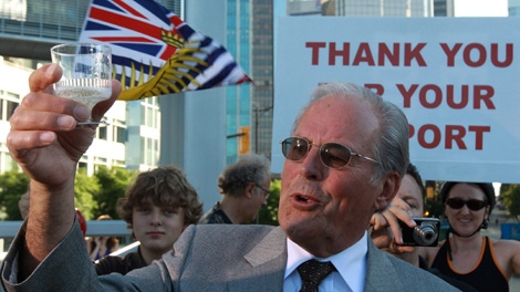 Former British Columbia premier Bill Vander Zalm raises a glass of champagne in celebration during a news conference in Vancouver, B.C., on Wednesday August 11, 2010. (CP/Darryl Dyck)
