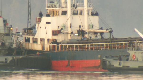 After three months at sea, the MV Sun Sea cargo ship carrying nearly 500 Tamil migrants is being towed into a Vancouver Island harbour on Friday, Aug. 13, 2010.