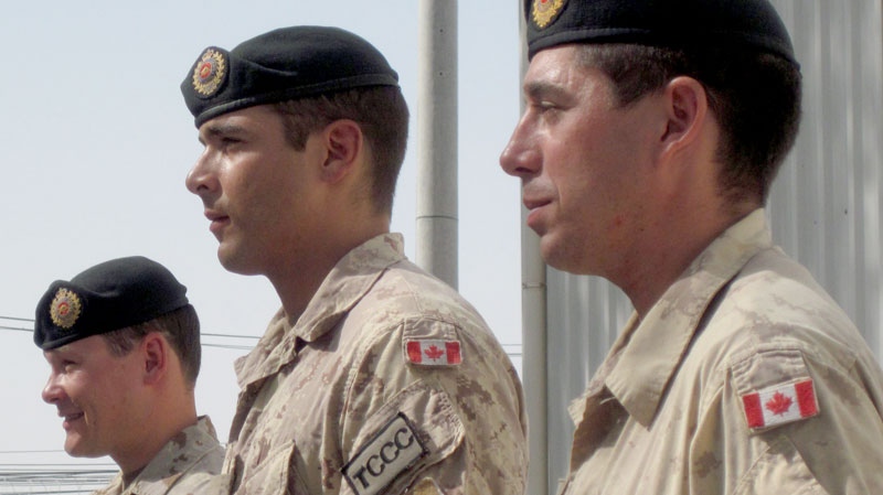 Three Canadian soldiers were awarded commendations Friday, Aug. 13, 2010 for their role in stopping an Aug. 3 attack on the main NATO military base in Kandahar. Sgt. Marc-Andre Rousseau, left to right, and Cpl. Joseph Henry, both members of the Combat Engineers in Kandahar from Valcartier, Que., as well as Sapper Kirk Farrell, of Petawawa, Ont., were outside the secure perimeter of the base when a group of insurgents attacked. (Dene Moore / THE CANADIAN PRESS)