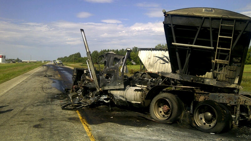 A car and a semi hauling an empty grain trailer collided head on. 