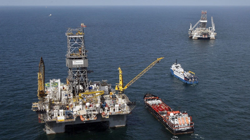 The Transocean Development Driller III, left, and the Transocean Development Driller II, right, the rigs responsible for drilling relief wells at the site of the Deepwater Horizon oil wellhead, are seen on the Gulf of Mexico near the coast of Louisiana, Saturday, Aug. 14, 2010. (AP Photo/Patrick Semansky)