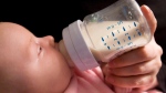 A six-week-old baby girl drinks from a baby bottle thought to contain compound bisphenol A in North Vancouver in this April 18, 2008. (Jonathan Hayward / THE CANADIAN PRESS)