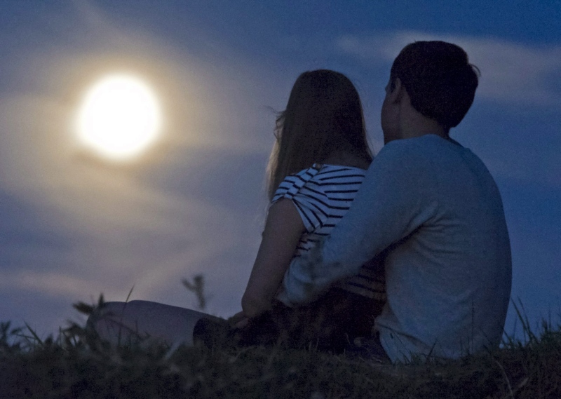 A man and a woman in front of the waning full moon in Erfurt, central Germany, Thursday, Aug. 2, 2012. (AP / Jens Meyer)