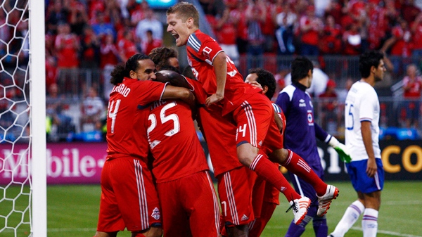 Toronto FC players jump onto Martin Saric, not visible, after he scored against the Cruz Azul during the first half of a CONCACAF Champions League soccer game in Toronto on Tuesday, Aug. 17, 2010. (Nathan Denette / The Canadian Press)