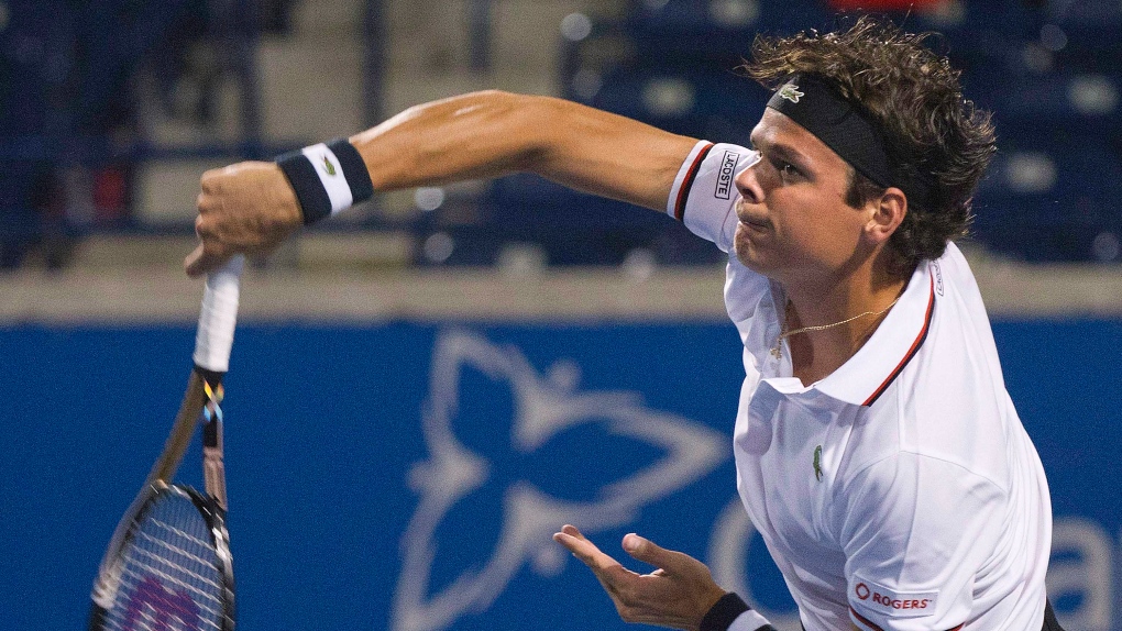 Milos Raonic of Canada serves the ball against John Isner of the United States during Rogers Cup