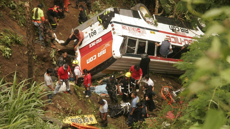 Rescuers and paramedics search for survivors after a passenger bus negotiating a downhill curve on Wednesday Aug.18, 2010 plunged off a Philippine mountain highway into a 30-metre ravine in Tuba township, Benguet province in northern Philippines. (AP Photo/Jayjay Landingin)