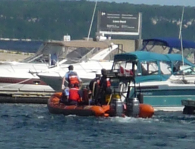 Rescue personnel bring the missing 63-year-old woman and a 10-year-old child to Lion's Head dock on Georgian Bay, Wednesday, Aug. 18, 2010. (Anna Gardiner / MyNews.CTV.ca)