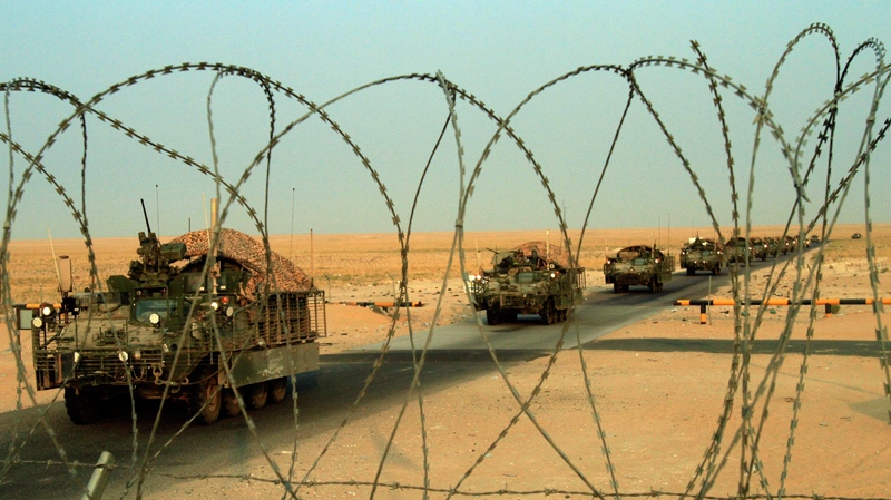 A column of U.S. Army Stryker armored vehicles cross the border from Iraq into Kuwait on Wednesday, Aug. 18, 2010. (AP /  Maya Alleruzzo)