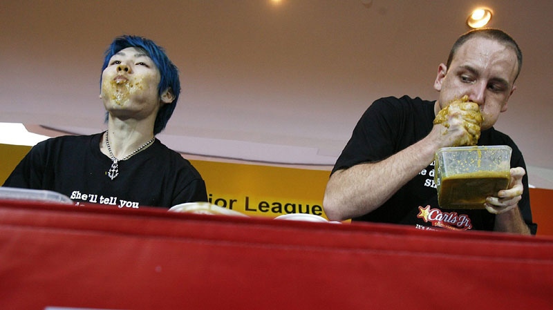 Takeru Kobayashi, of Japan left, and Joey Chestnut of the U.S. are seen during the Major League Eating contest Asia Face-off on Sunday July 27, 2008 in Singapore. (AP Photo/ Wong Maye-E)