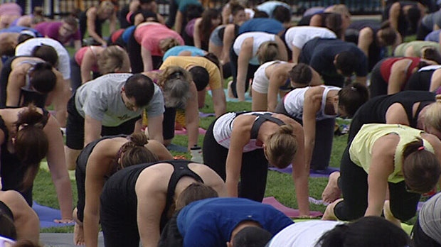 Nearly 2,400 people took part in a mass yoga class on the grounds of Parliament Hill Wednesday.