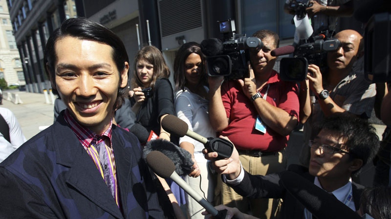 Japanese eating champion Takeru Kobayashi smiles as he speaks to the media after leaving court in New York, Thursday, Aug. 5, 2010. (AP Photo/Seth Wenig)