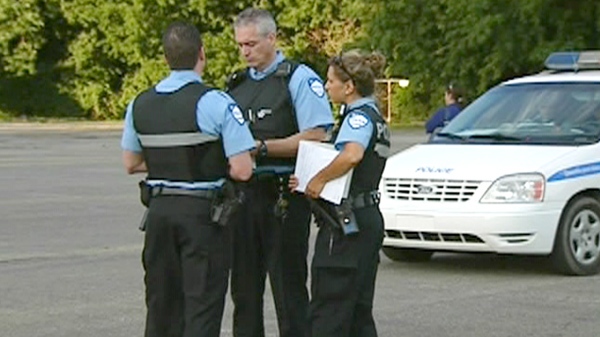 Montreal police officers at the scene where a 16-year-old boy was critically injured in a car surfing incident in Dorval on Friday, Aug. 20, 2010.