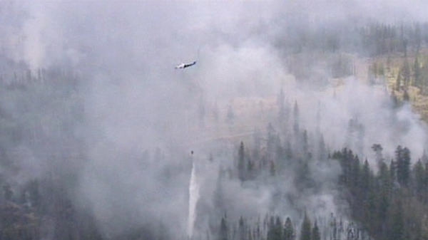 A helicopter drops water on a wildfire near Meldrum Creek, B.C. on Saturday, Aug. 21, 2010.