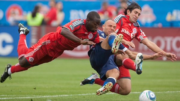 New York Red Bull's Joel Lindpere is crowded off the ball by Toronto FC's Nana Attakora (left) and Nick Garcia during the first half MLS soccer action in Toronto on Saturday August 21, 2010. (Chris Young / THE CANADIAN PRESS)