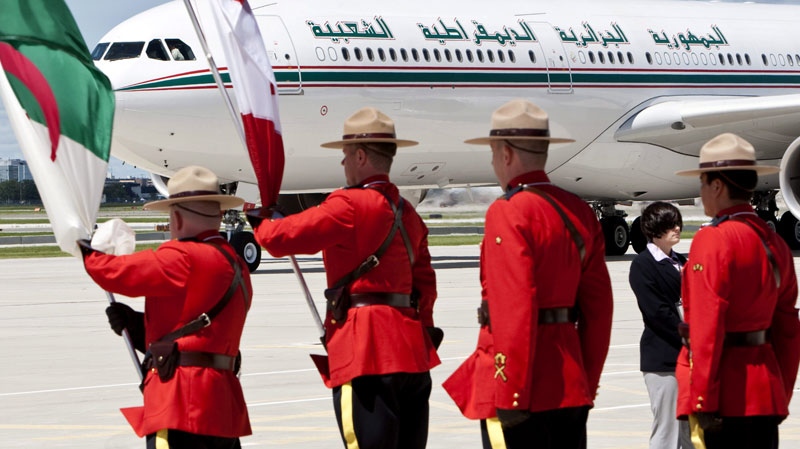 RCMP officers line up for the arrival of the airplane carrying Abdelaziz Bouteflika, President of Algeria, as he arrives to participate in the G20 Summit, Thursday, June 24, 2010 in Toronto. (Paul Chiasson / THE CANADIAN PRESS)