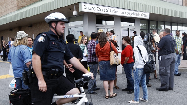 Members of the media and police gather around people scheduled to make their court appearances charged with various offences stemming from the G20 summit in Toronto on Monday, Aug. 23, 2010. (Nathan Denette / THE CANADIAN PRESS)  