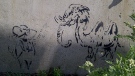 Stenciled graffiti vandalism is shown.