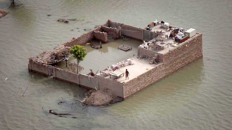 A Pakistani resident stands on the roof of his house which is surrounded by flood waters, near Thul in Sindh province, southern Pakistan Tuesday, Aug. 24, 2010. (AP / Kevin Frayer)