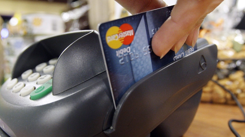 A customer swipes a debit card in this Nov. 2, 2009 file photo.