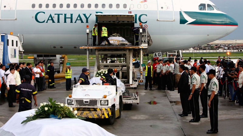 Crates containing the coffins of Hong Kong tourists who were killed in this week's hostage crisis are loaded onto a chartered Cathay Pacific plane bound for Hong Kong at the Ninoy Aquino International Airport in Manila, Philippines, Wednesday, Aug. 25, 2010. (AP / Bullit Marquez) 