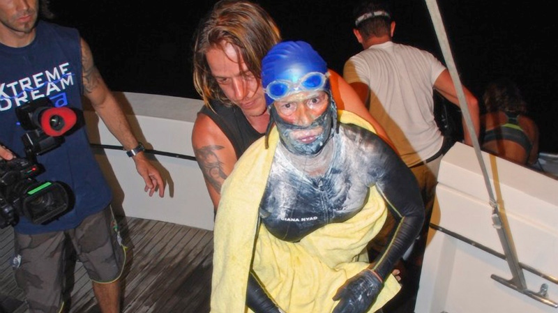 Endurance swimmer Diana Nyad is aided after she was pulled out of the water between Cuba and the Florida Keys early Tuesday, Aug. 21, 2012. (Diana Nyad via the Florida Keys News Bureau, Christi Barli)