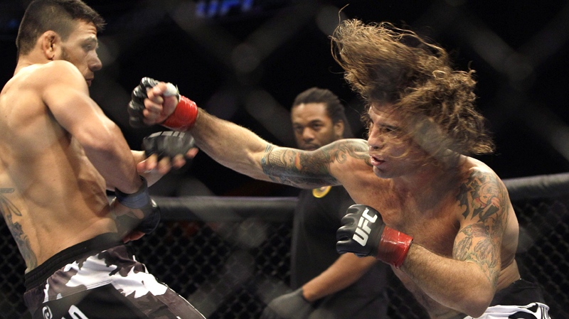Clay Guida, right, swings at Rafael Dos Anjos during a UFC  mixed martial arts match in Oakland, Calif., Saturday, Aug. 7, 2010. Guida won by submission in the third round. (AP / Jeff Chiu)