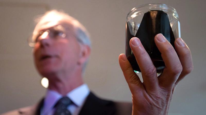 David Black holds a jar of raw bitumen in Vancouver, B.C., on Aug. 17, 2012.