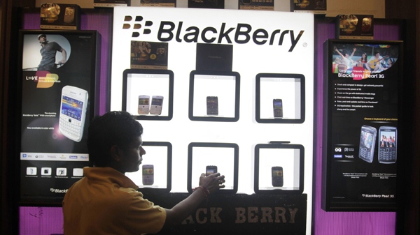 A shopkeeper displays BlackBerry mobile phones in his shop in Ahmadabad, India. (AP / Ajit Solanki)