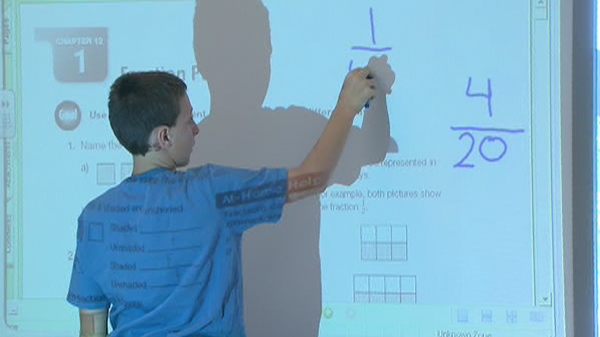 A student works on fractions during a math lesson at his Toronto school, Monday. Aug. 30, 