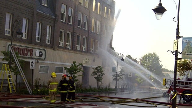 Firefighters douse an apartment building in Amherst, N.S.