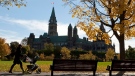 A woman walks with a stroller at Major's Hill Park in Ottawa on Monday, Oct 11, 2010. (Pawel Dwulit / THE CANADIAN PRESS)