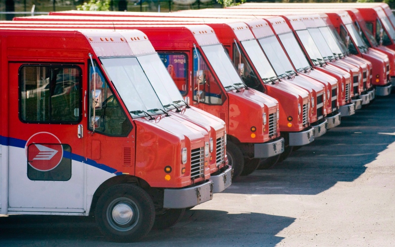 Canada Post vehicles sit outside a sorting depot in the Ville St-Laurent borough of Montreal, in this June 6, 2011 photo. (Graham Hughes / THE CANADIAN PRESS)
