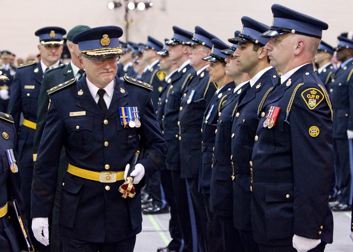 New OPP Commissioner Chris Lewis, left, inspects a line of officers during the Change of Command ceremony in Toronto Tuesday, August 31, 2010. (Darren Calabrese / THE CANADIAN PRESS)
