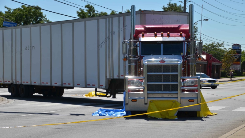 Police investigate after a tractor-trailer struck and killed an 81-year-old woman on Burnhamthorpe Road West near Wolfedale Road in Mississauga on Wednesday, Aug. 29, 2012. (Andrew Collins)