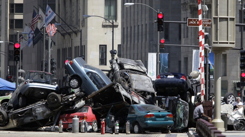 Cars are seen piled up in a plaza along Michigan Avenue in downtown Chicago, Friday, July 16, 2010, during filming of the movie "Transformers 3." (AP Photo/Kiichiro Sato)